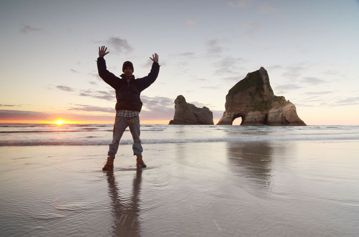 Photographer at Archway Islands, Wharariki Beach, South Island, New Zealand