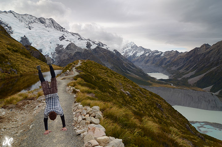 Hiker doing handstand at the Sealy Tarns, Mt Cook / Aoraki National Park