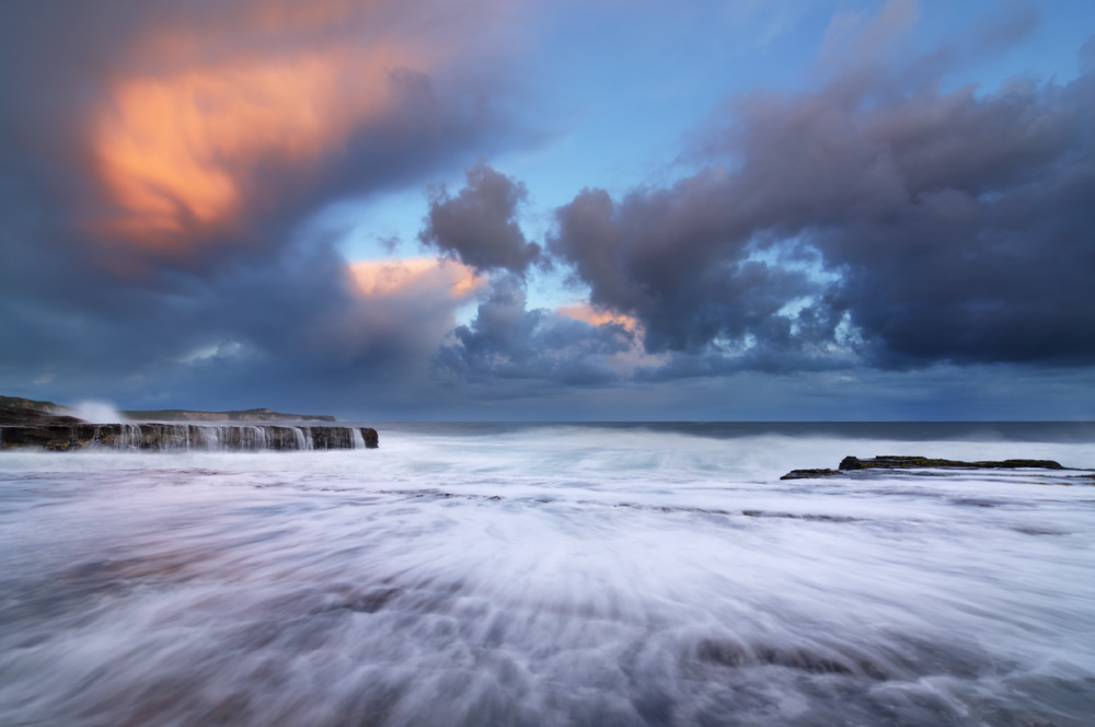 photo of storm clouds and ocean waves at hole in the wall beach santa cruz california