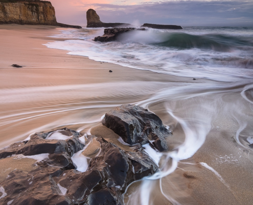four-mile-beach-santa-cruz-rocks-waves-sunset